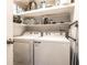 Functional laundry room with washer, dryer and shelving for storage at 3840 Knollton Rd # A, Indianapolis, IN 46228