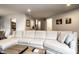 Bright living room featuring a large sectional sofa, neutral paint, recessed lighting and decor at 3840 Knollton Rd # A, Indianapolis, IN 46228