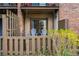 Second floor patio featuring sliding glass doors, privacy fence and two chairs at 3840 Knollton Rd # A, Indianapolis, IN 46228