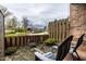 Cozy patio with two chairs and a view of the neighborhood's landscaping and flowering trees at 3840 Knollton Rd # A, Indianapolis, IN 46228