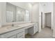 A bathroom features a double sink vanity with white cabinets and countertops at 4825 Topaz Pointe Blvd, Lawrence, IN 46235