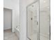 A bathroom includes a tub and a glass enclosed shower with white tile at 4825 Topaz Pointe Blvd, Lawrence, IN 46235