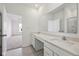 A bathroom with wood-look floors has a double sink vanity and white countertops at 4825 Topaz Pointe Blvd, Lawrence, IN 46235