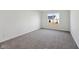 A well-lit bedroom shows carpeted floors, a window and neutral paint at 4825 Topaz Pointe Blvd, Lawrence, IN 46235