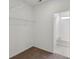 An empty carpeted walk-in closet with wire shelving and an adjoining bathroom with a tub at 4825 Topaz Pointe Blvd, Lawrence, IN 46235