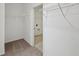 An empty carpeted walk-in closet with wire shelving, next to a laundry room with tile floors at 4825 Topaz Pointe Blvd, Lawrence, IN 46235