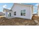 Exterior view of the home, displaying siding, windows, and a small patio at 4825 Topaz Pointe Blvd, Lawrence, IN 46235