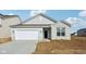 Charming single-story home featuring a two-car garage and classic vinyl siding at 4825 Topaz Pointe Blvd, Lawrence, IN 46235