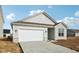 Charming single-story home featuring a two-car garage and classic vinyl siding at 4825 Topaz Pointe Blvd, Lawrence, IN 46235