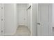 Hallway with white trim and tile floors, showing closet doors and white walls at 4825 Topaz Pointe Blvd, Lawrence, IN 46235