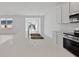 Bright kitchen with stainless steel sink, quartz countertops and a view to the backyard at 4825 Topaz Pointe Blvd, Lawrence, IN 46235