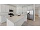 Modern kitchen featuring white cabinetry, stainless appliances, and a spacious center island at 4825 Topaz Pointe Blvd, Lawrence, IN 46235