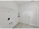 Empty laundry room with tile floors, a utility sink hookup, and a white door at 4825 Topaz Pointe Blvd, Lawrence, IN 46235