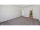 A carpeted bedroom with white walls shows neutral carpeting and an entrance at 4825 Topaz Pointe Blvd, Lawrence, IN 46235