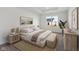 Serene main bedroom featuring a tray ceiling, large window, neutral tones, and stylish decor at 4825 Topaz Pointe Blvd, Lawrence, IN 46235