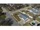 Wide aerial view of a neighborhood showing a single story house with metal roof and small pool at 504 Iroquois Dr, Anderson, IN 46012