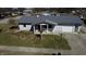 Aerial view of a single story house with new metal roof and well kept front yard at 504 Iroquois Dr, Anderson, IN 46012