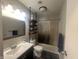 Cozy bathroom features modern vanity, tiled shower, and a mounted shelving unit for extra storage at 504 Iroquois Dr, Anderson, IN 46012