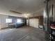 Functional garage with utility equipment, overhead lighting, and a roll up door for easy access at 504 Iroquois Dr, Anderson, IN 46012
