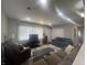 Bright living room featuring large windows, recessed lighting, and comfortable furniture at 504 Iroquois Dr, Anderson, IN 46012