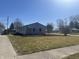 View of the large front yard of a single story home with bare trees at 504 Iroquois Dr, Anderson, IN 46012