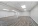 Spacious finished basement with laminate flooring and white painted ceiling at 5214 Woodfield Dr, Carmel, IN 46033