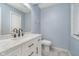 A well-lit bathroom with a modern vanity, black fixtures, and tile flooring, ready for relaxation at 5214 Woodfield Dr, Carmel, IN 46033