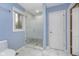 Bathroom featuring a glass enclosed shower with modern fixtures and white marble patterned tile at 5214 Woodfield Dr, Carmel, IN 46033