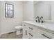 A modern bathroom with white cabinets, marble countertops, and stylish black fixtures providing a clean aesthetic at 5214 Woodfield Dr, Carmel, IN 46033