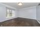 A bright bedroom with a large window and hardwood floors is ready to be customized to your liking at 5214 Woodfield Dr, Carmel, IN 46033