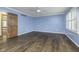A large bedroom boasts hardwood floors and abundant natural light, offering a serene and inviting space at 5214 Woodfield Dr, Carmel, IN 46033