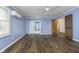 A spacious bedroom features beautiful hardwood floors, a ceiling fan, and natural light for a relaxing atmosphere at 5214 Woodfield Dr, Carmel, IN 46033