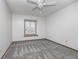 Bright bedroom with neutral carpet, ceiling fan, and lots of natural light at 5214 Woodfield Dr, Carmel, IN 46033