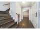 The home's entry features wooden stairs, hardwood floors, and bright light from the door and nearby rooms at 5214 Woodfield Dr, Carmel, IN 46033