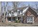 Charming two-story brick home featuring dormer windows and a covered front porch at 5214 Woodfield Dr, Carmel, IN 46033