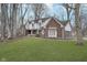 Beautiful two-story brick home with well-manicured lawn, mature trees, and an attached two-car garage at 5214 Woodfield Dr, Carmel, IN 46033
