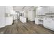 Open-concept kitchen featuring white cabinets, granite countertops, and hardwood floors at 5214 Woodfield Dr, Carmel, IN 46033