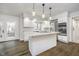 Bright kitchen with white cabinets, stainless appliances, center island, and hardwood floors at 5214 Woodfield Dr, Carmel, IN 46033