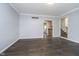 A bright living room showcases elegant crown molding, beautiful hardwood floors, and an open doorway to another room at 5214 Woodfield Dr, Carmel, IN 46033