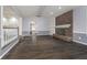 Inviting living room with a brick fireplace, built-in shelves, hardwood floors, and neutral paint colors at 5214 Woodfield Dr, Carmel, IN 46033