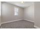 Bedroom featuring gray carpet, neutral walls, white trim, and bright window at 569 N Tacoma Ave, Indianapolis, IN 46201