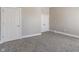 Bedroom featuring gray carpet, neutral walls, white trim and doors, and closet storage at 569 N Tacoma Ave, Indianapolis, IN 46201
