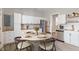 Dining area with a circular table, set for four, next to a modern kitchen at 569 N Tacoma Ave, Indianapolis, IN 46201