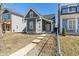 Charming gray two-story home with manicured lawn and inviting curb appeal on a sunny day at 569 N Tacoma Ave, Indianapolis, IN 46201