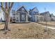 Charming gray two-story home with manicured lawn and inviting curb appeal on a sunny day at 569 N Tacoma Ave, Indianapolis, IN 46201