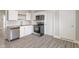 Modern kitchen with stainless steel appliances, white cabinets, and laminate flooring at 569 N Tacoma Ave, Indianapolis, IN 46201
