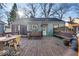 Inviting backyard features a spacious wooden deck with bench seating and mature trees at 5935 Compton St, Indianapolis, IN 46220