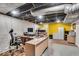 Finished basement offers a workspace with a large desk, storage, and bright yellow door at 5935 Compton St, Indianapolis, IN 46220