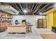 Finished basement with bright yellow doors offers a flexible workspace with a large desk and storage at 5935 Compton St, Indianapolis, IN 46220