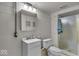 Bathroom with a white vanity, toilet, and tiled shower with glass door and updated fixtures at 5935 Compton St, Indianapolis, IN 46220